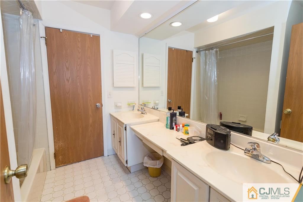 405 Maplecrest Road, Unit 405 Edison, NJ 08820 - Photo 23 of 33 a bathroom with a sink and a mirror