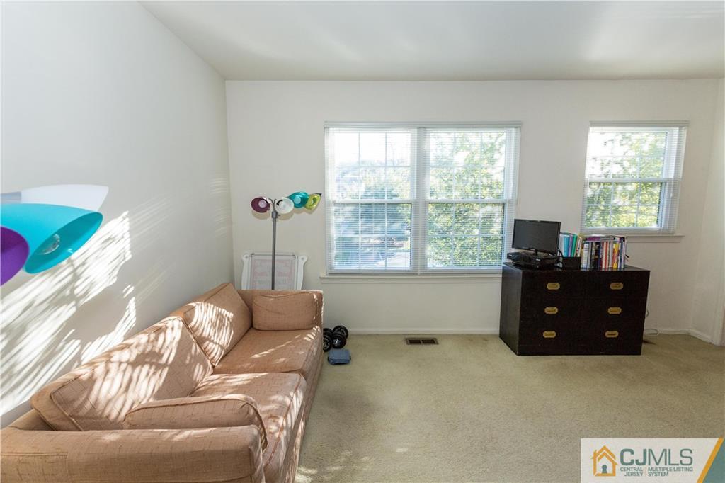 405 Maplecrest Road, Unit 405 Edison, NJ 08820 - Photo 24 of 33 a living room with furniture and a window
