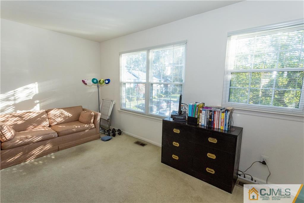 405 Maplecrest Road, Unit 405 Edison, NJ 08820 - Photo 26 of 33 a bedroom with a bed and window