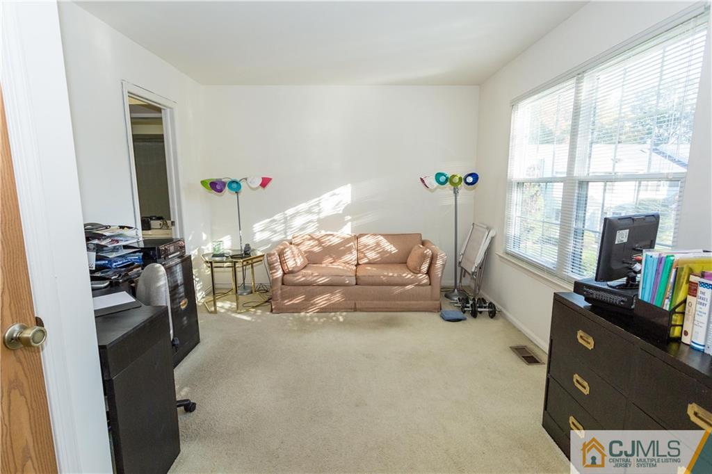 405 Maplecrest Road, Unit 405 Edison, NJ 08820 - Photo 27 of 33 a room with furniture and a window
