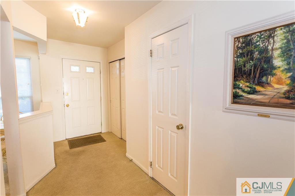 405 Maplecrest Road, Unit 405 Edison, NJ 08820 - Photo 4 of 33 a view of a bedroom with wooden floor and windows
