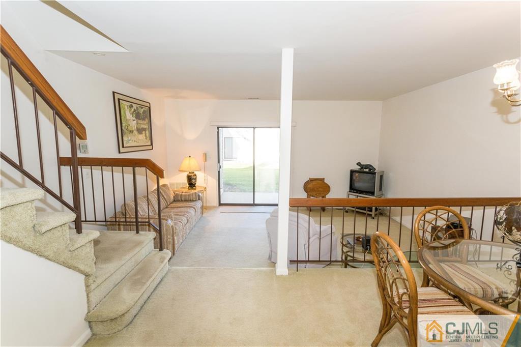 405 Maplecrest Road, Unit 405 Edison, NJ 08820 - Photo 5 of 33 a view of a bedroom with furniture wooden floor and windows