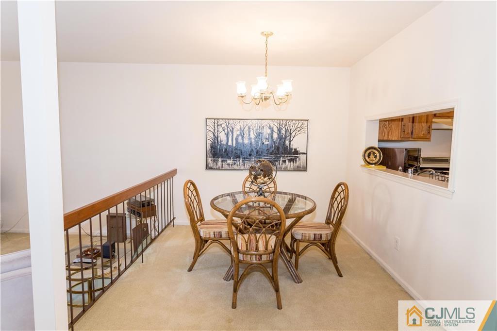 405 Maplecrest Road, Unit 405 Edison, NJ 08820 - Photo 6 of 33 a view of a dining room with furniture