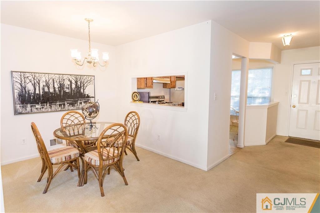 405 Maplecrest Road, Unit 405 Edison, NJ 08820 - Photo 7 of 33 a dining room with furniture and window