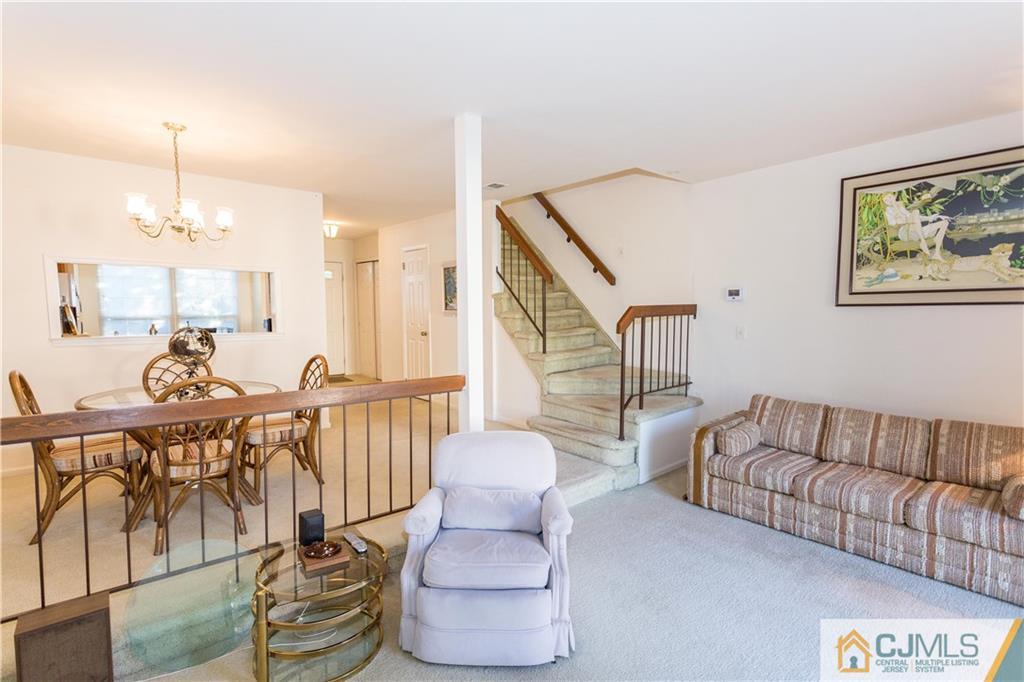 405 Maplecrest Road, Unit 405 Edison, NJ 08820 - Photo 8 of 33 a living room with furniture and wooden floor