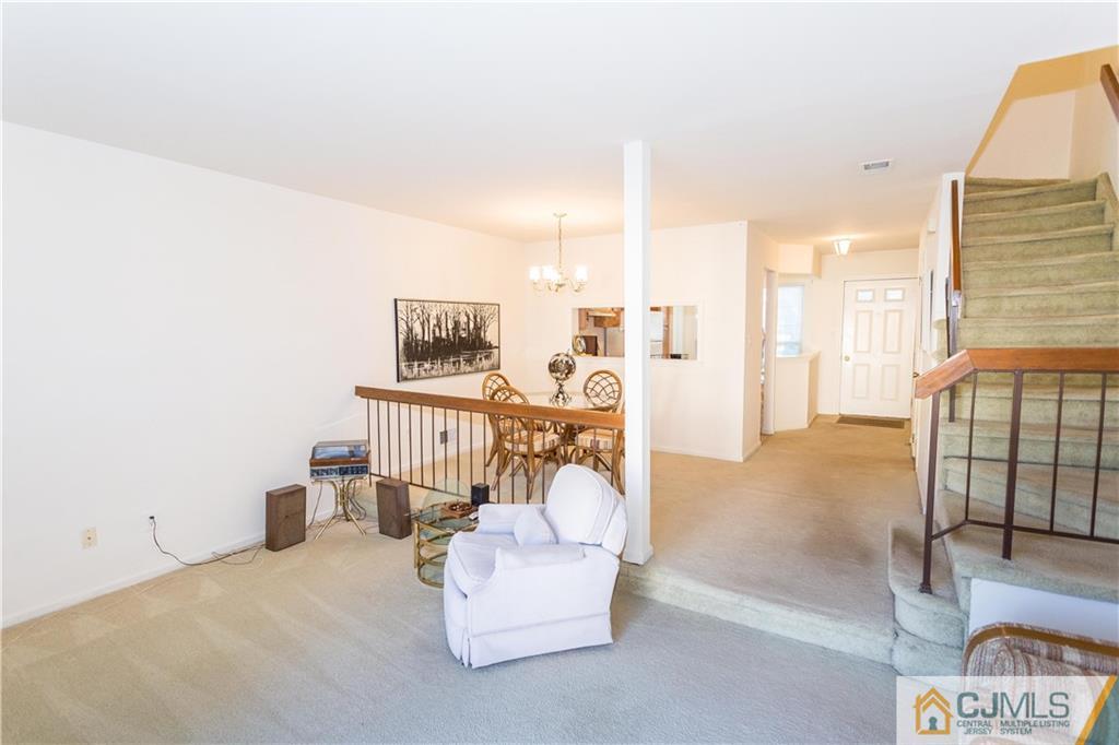 405 Maplecrest Road, Unit 405 Edison, NJ 08820 - Photo 9 of 33 a bedroom with furniture and a chandelier