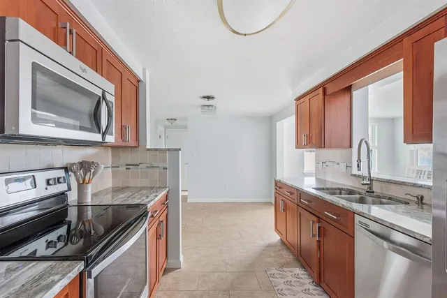 a kitchen that has a sink and a stove