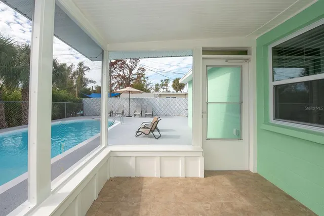 a living room with a large window and a table