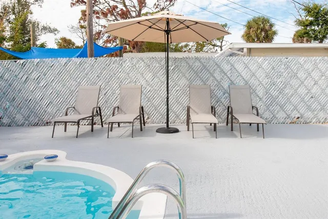 a view of a swimming pool with a patio