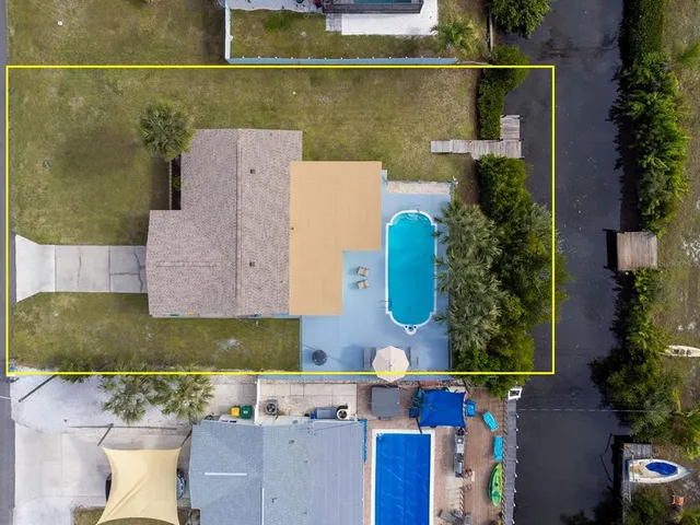 an aerial view of a house with a yard