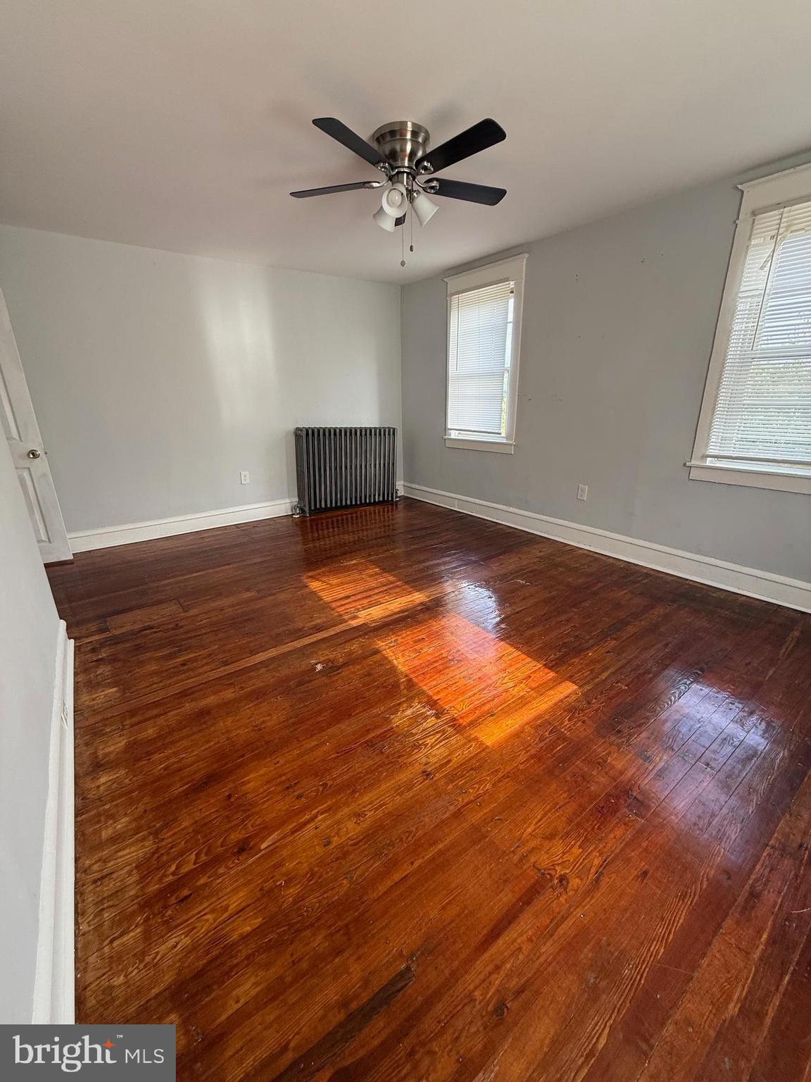 1300 South Merrimac Road Camden, NJ 08104 - Photo 15 of 25 an empty room with wooden floor and windows