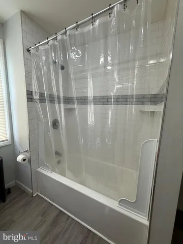 a bathroom with a glass shower door