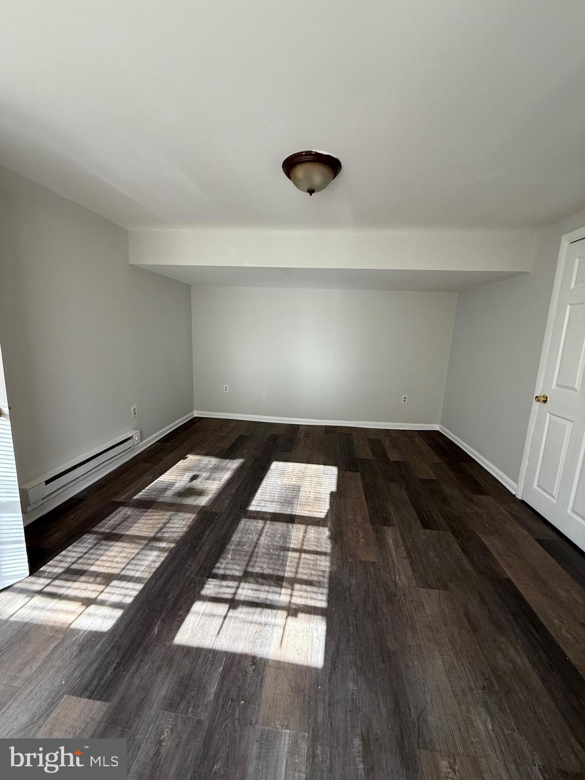 1300 South Merrimac Road Camden, NJ 08104 - Photo 22 of 25 a bedroom with bed and wooden floor