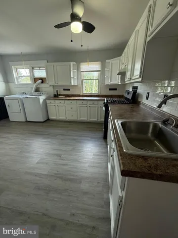 a kitchen with stainless steel appliances granite countertop a sink a stove and a refrigerator