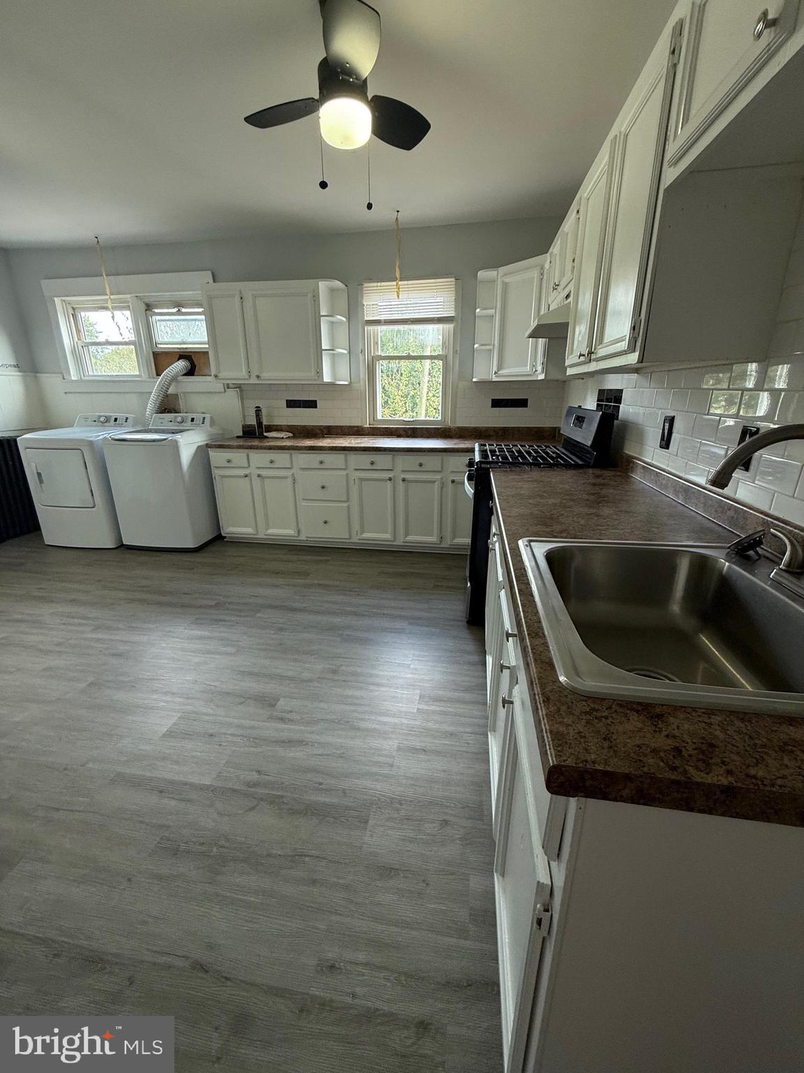 1300 South Merrimac Road Camden, NJ 08104 - Photo 9 of 25 a kitchen with stainless steel appliances granite countertop a sink a stove and a refrigerator