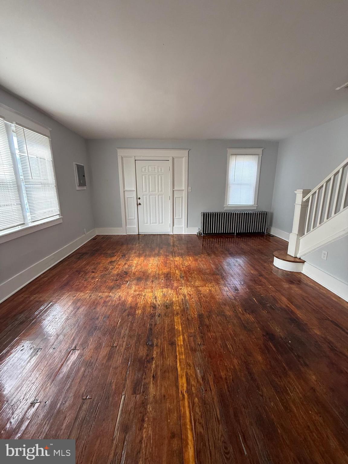1300 South Merrimac Road Camden, NJ 08104 - Photo 10 of 25 an empty room with wooden floor and windows