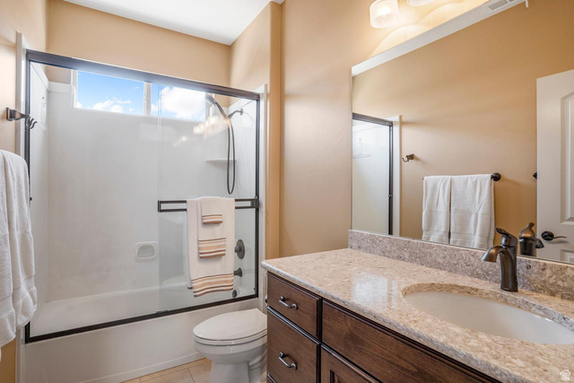 1587 Whitestone Drive St. George, UT 84790 - Photo 19 of 36 Bathroom featuring a single vanity with a light-colored countertop, an undermount sink, and a dark wood-finish cabinet