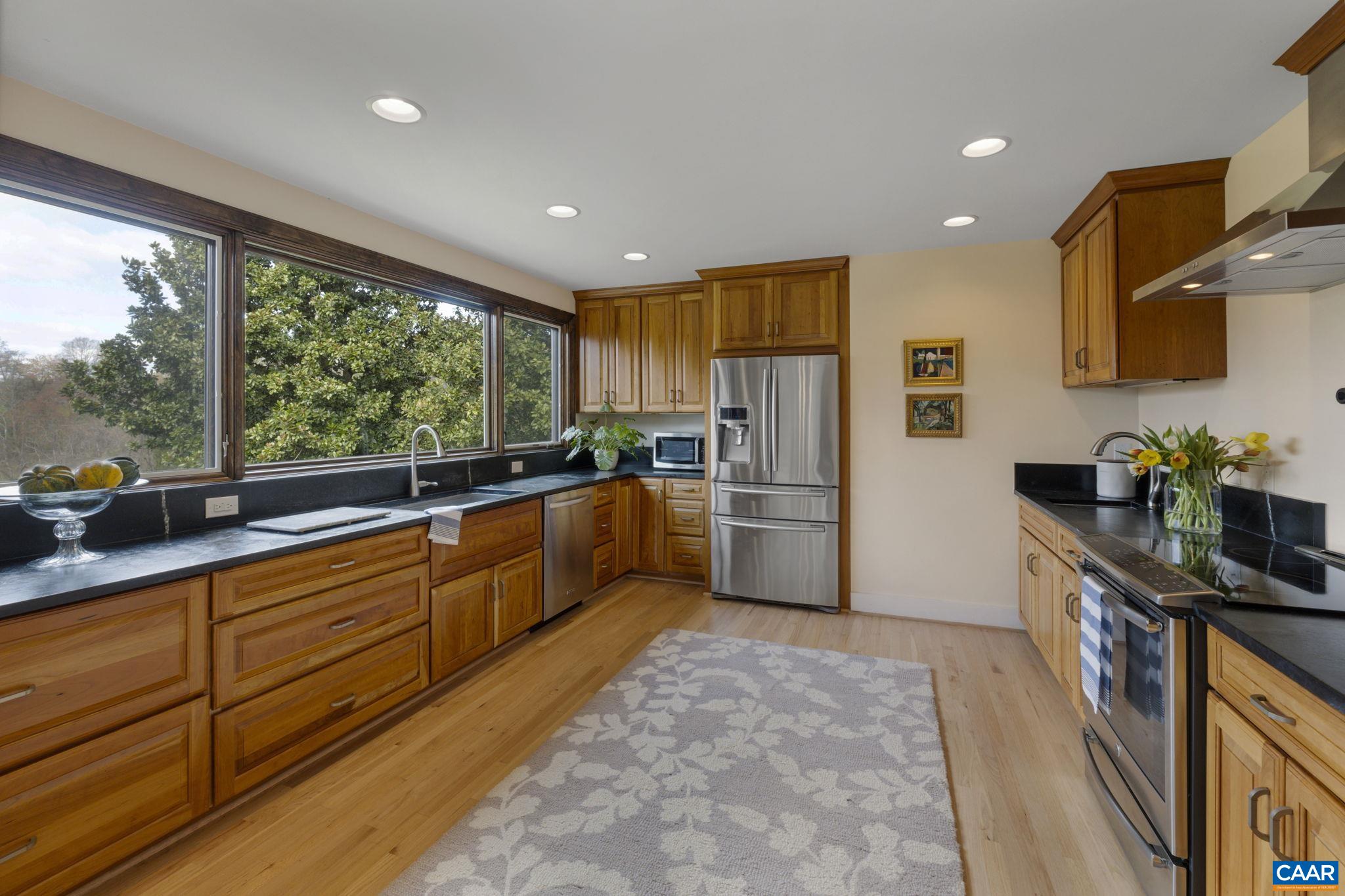570 Rodes Drive Charlottesville, VA 22903 - Photo 17 of 75 a kitchen with granite countertop a refrigerator and a sink