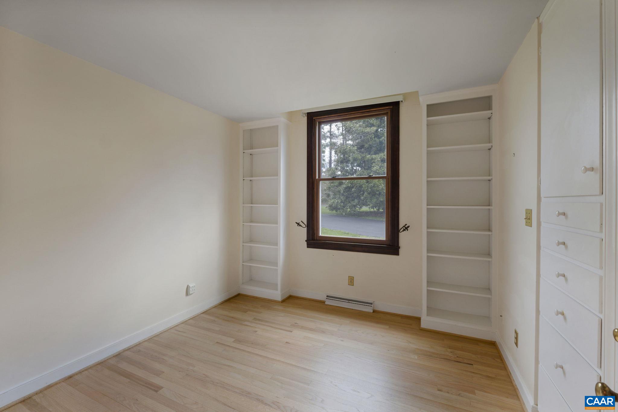 570 Rodes Drive Charlottesville, VA 22903 - Photo 37 of 75 an empty room with wooden floor and windows