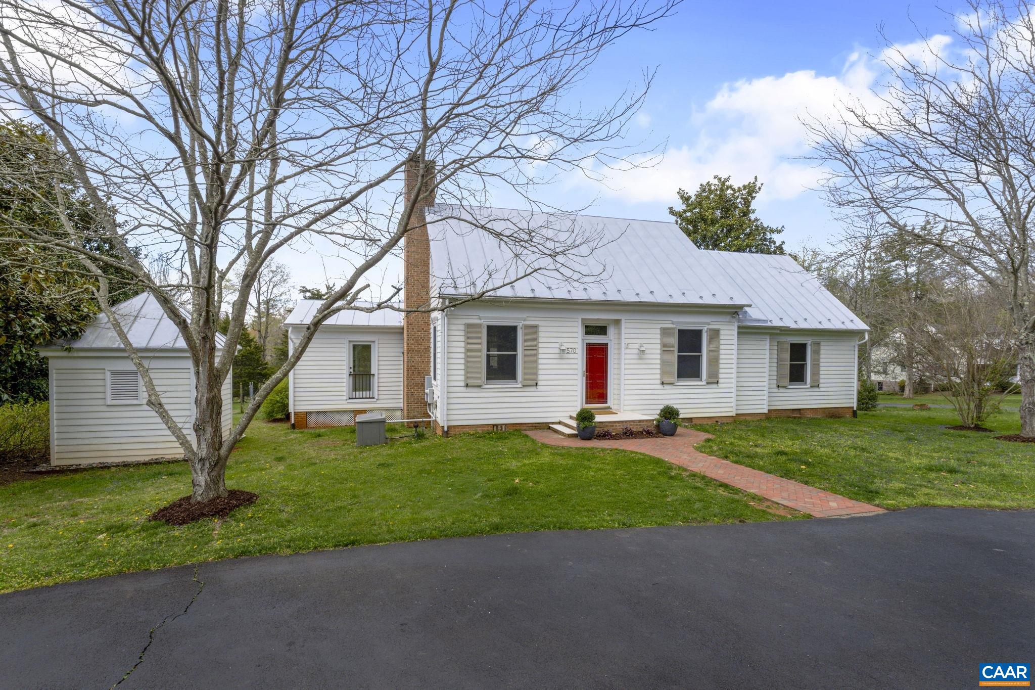 570 Rodes Drive Charlottesville, VA 22903 - Photo 4 of 75 a front view of a house with a yard and garage