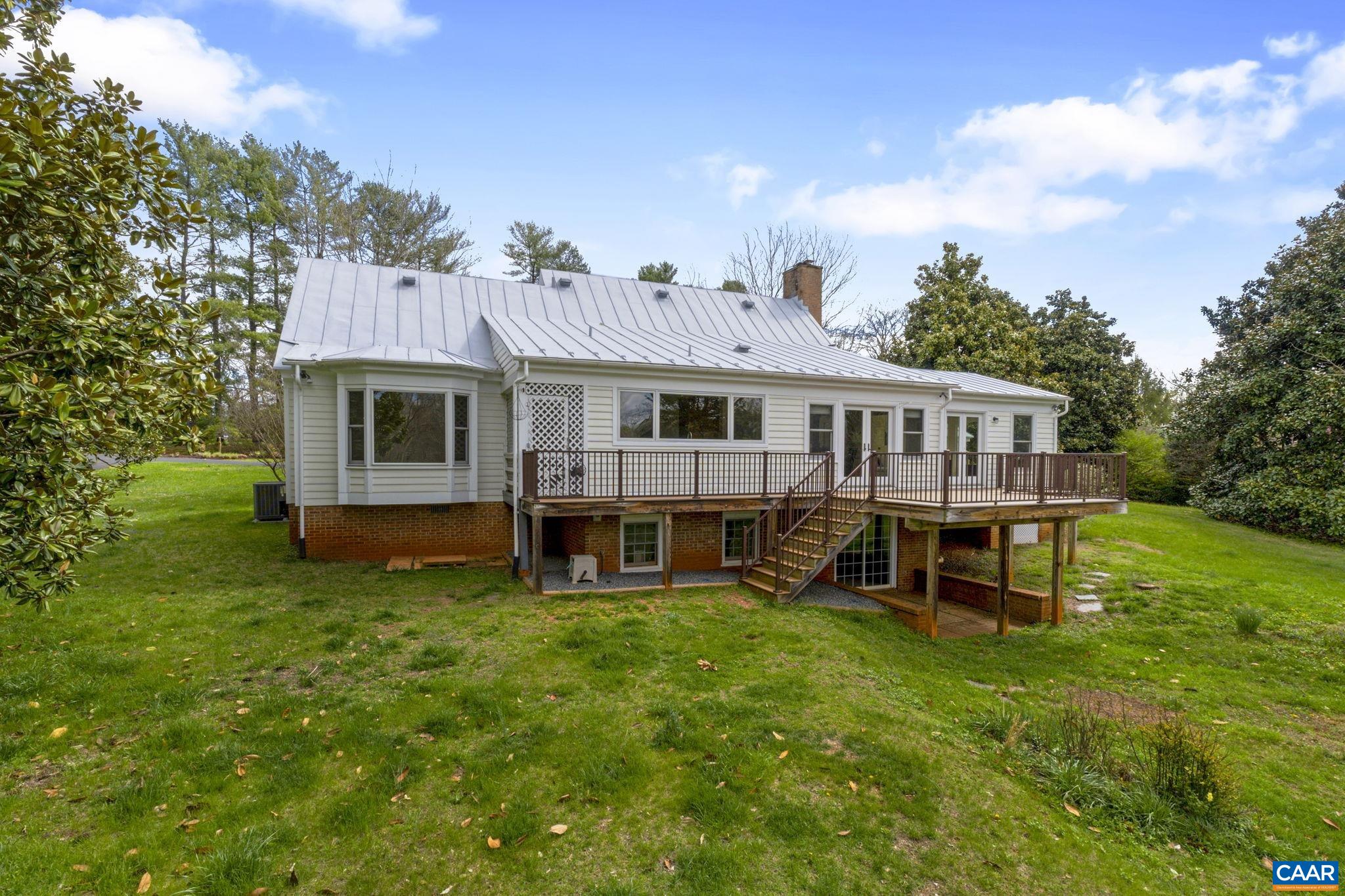 570 Rodes Drive Charlottesville, VA 22903 - Photo 49 of 75 a view of a house with a backyard and a patio