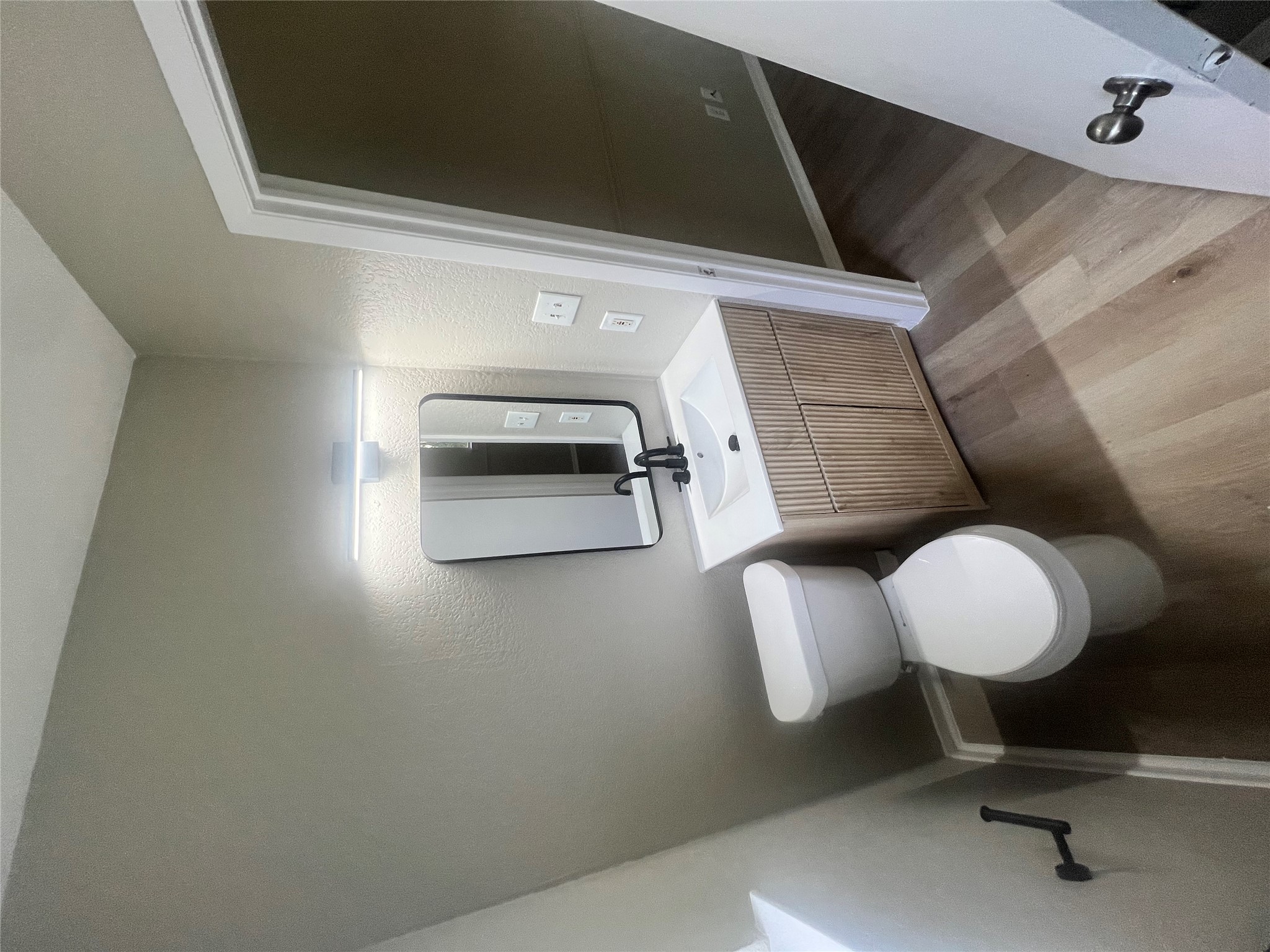 4620 Button Bend Road Austin, TX 78744 - Photo 10 of 22 A compact bath features a modern vanity and clean design for efficient daily routines.