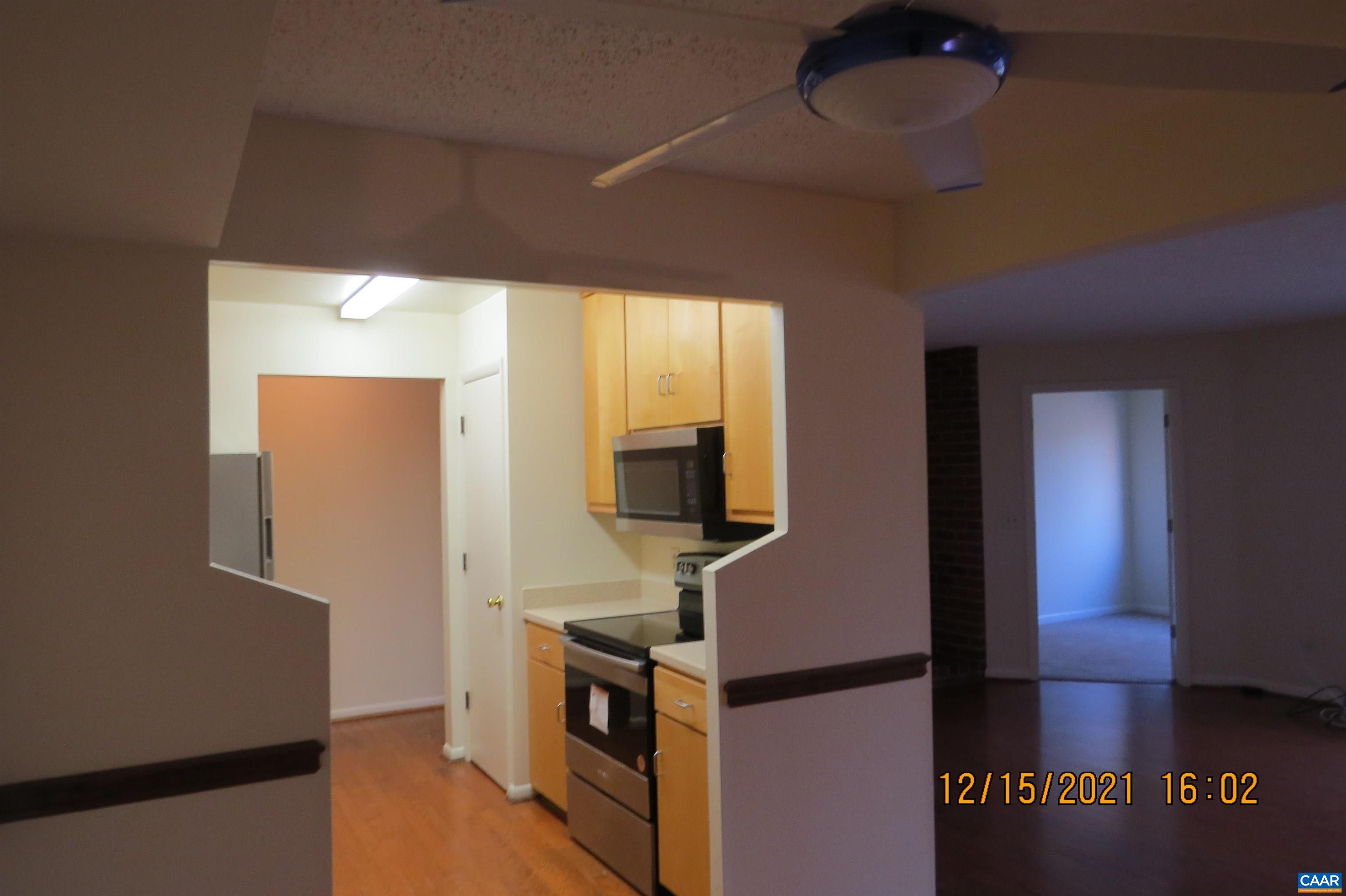 115 Turtle Creek Road, Unit 7 Charlottesville, VA 22901 - Photo 6 of 15 a kitchen with stainless steel appliances granite countertop a sink a stove top oven a counter space and cabinets