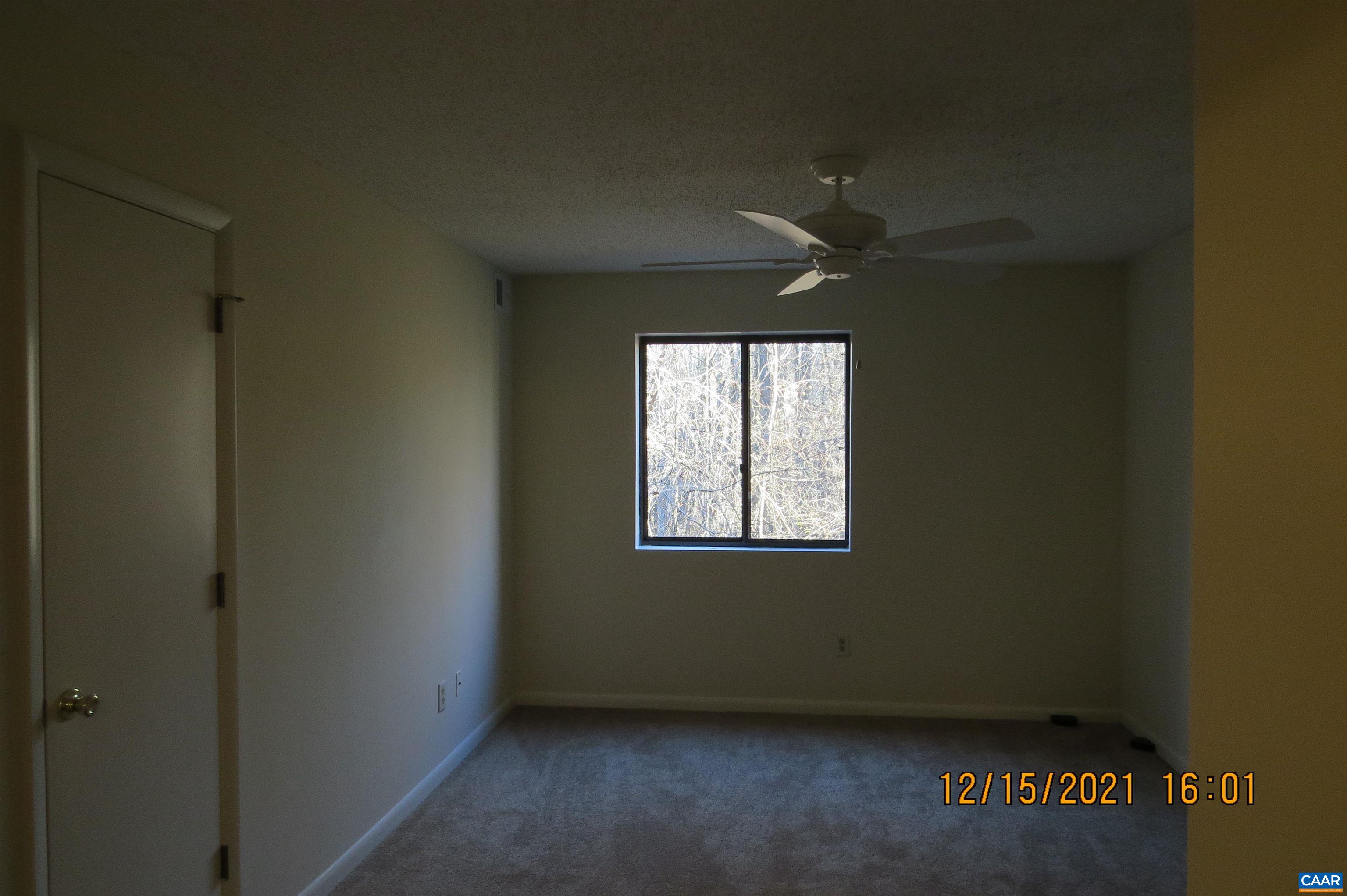 115 Turtle Creek Road, Unit 7 Charlottesville, VA 22901 - Photo 9 of 15 an empty room with a window and a ceiling fan