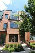 a front view of a house with plants