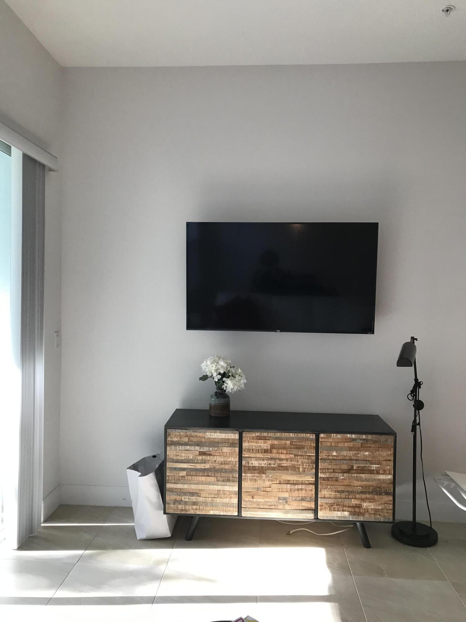 23045 Clear Echo Drive, Unit 76 Boca Raton, FL 33433 - Photo 15 of 35 a living room with a flat screen tv