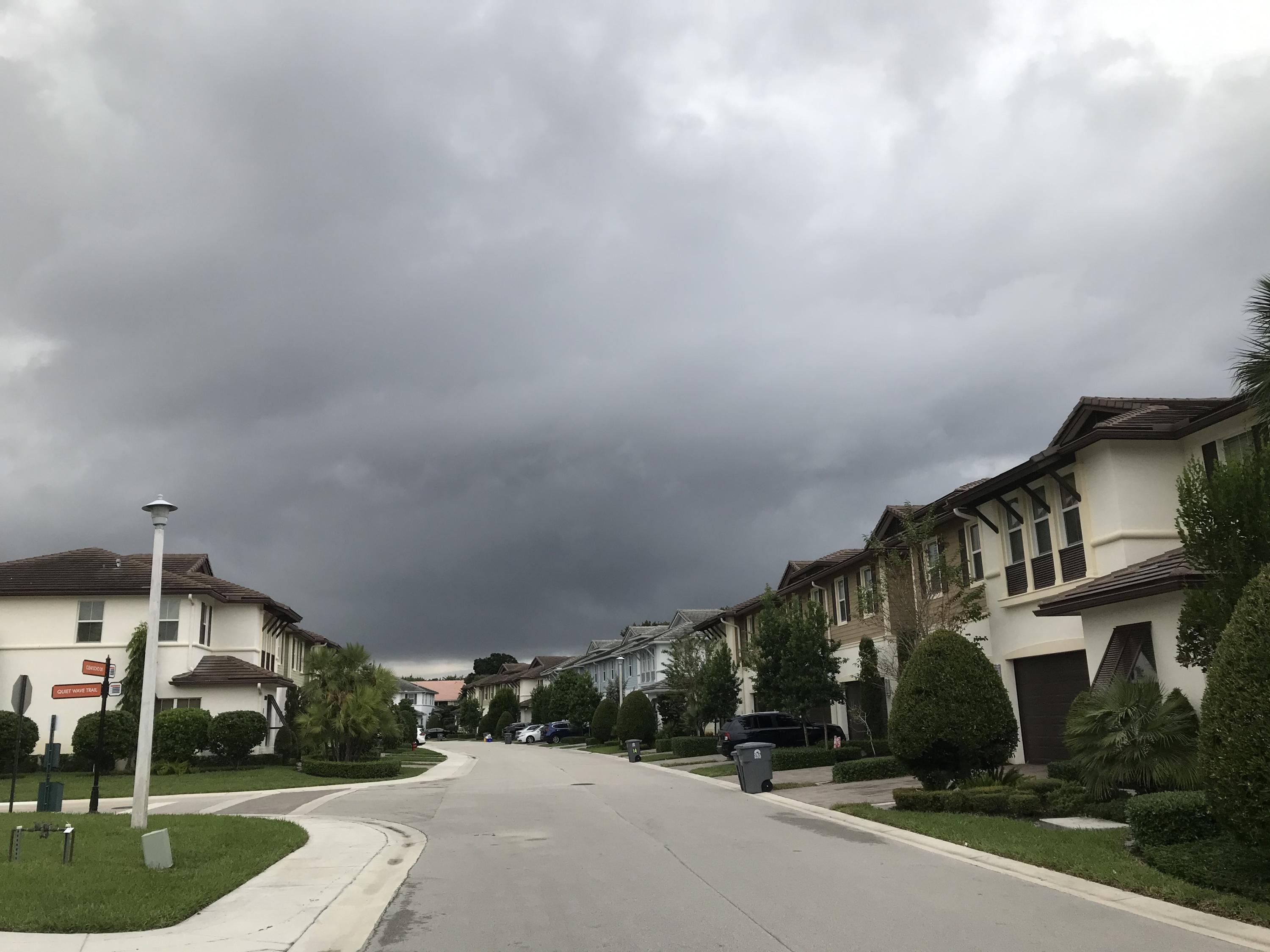 23045 Clear Echo Drive, Unit 76 Boca Raton, FL 33433 - Photo 2 of 35 a view of a street with a building in the background