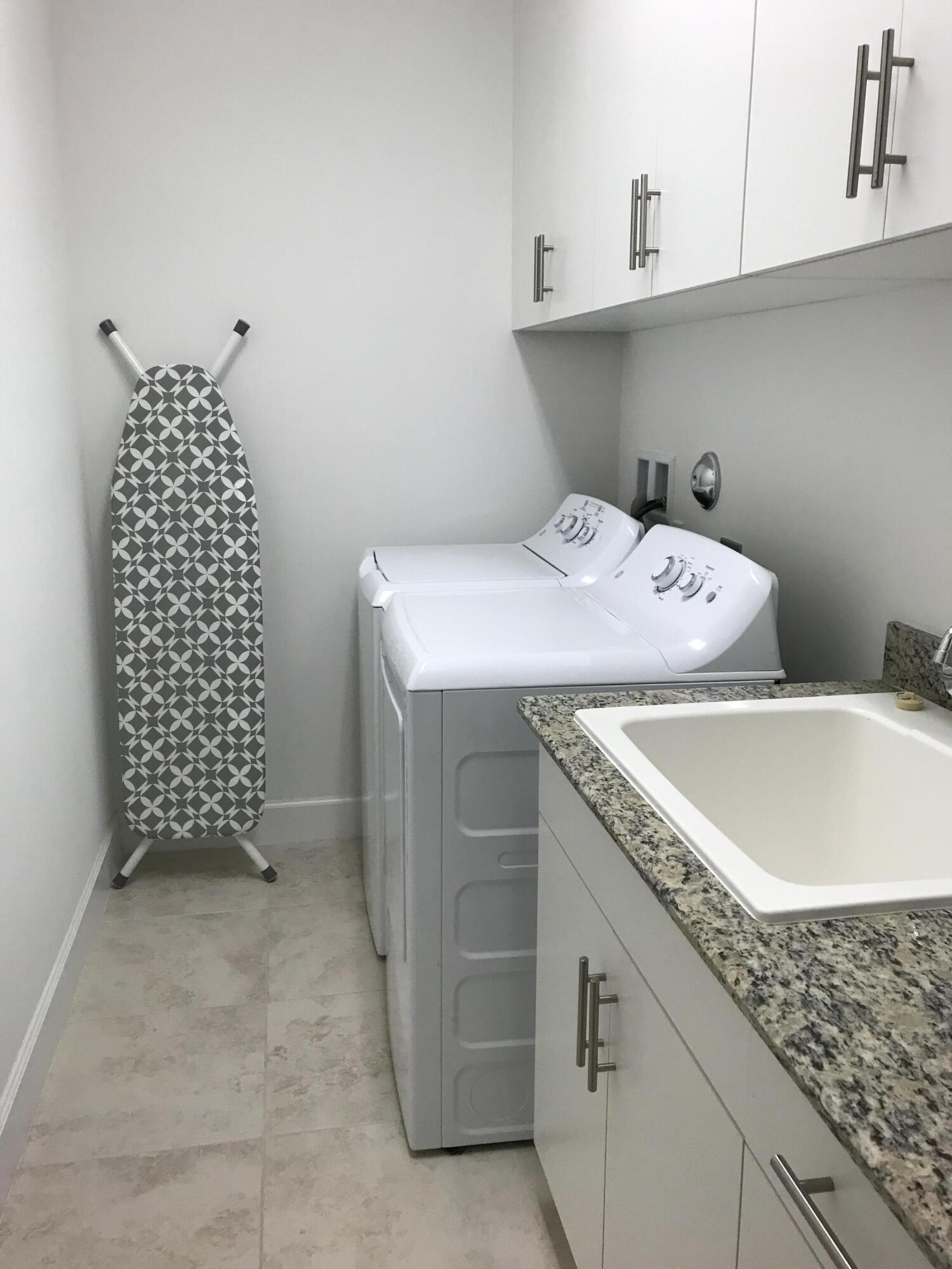 23045 Clear Echo Drive, Unit 76 Boca Raton, FL 33433 - Photo 21 of 35 a utility room with cabinets