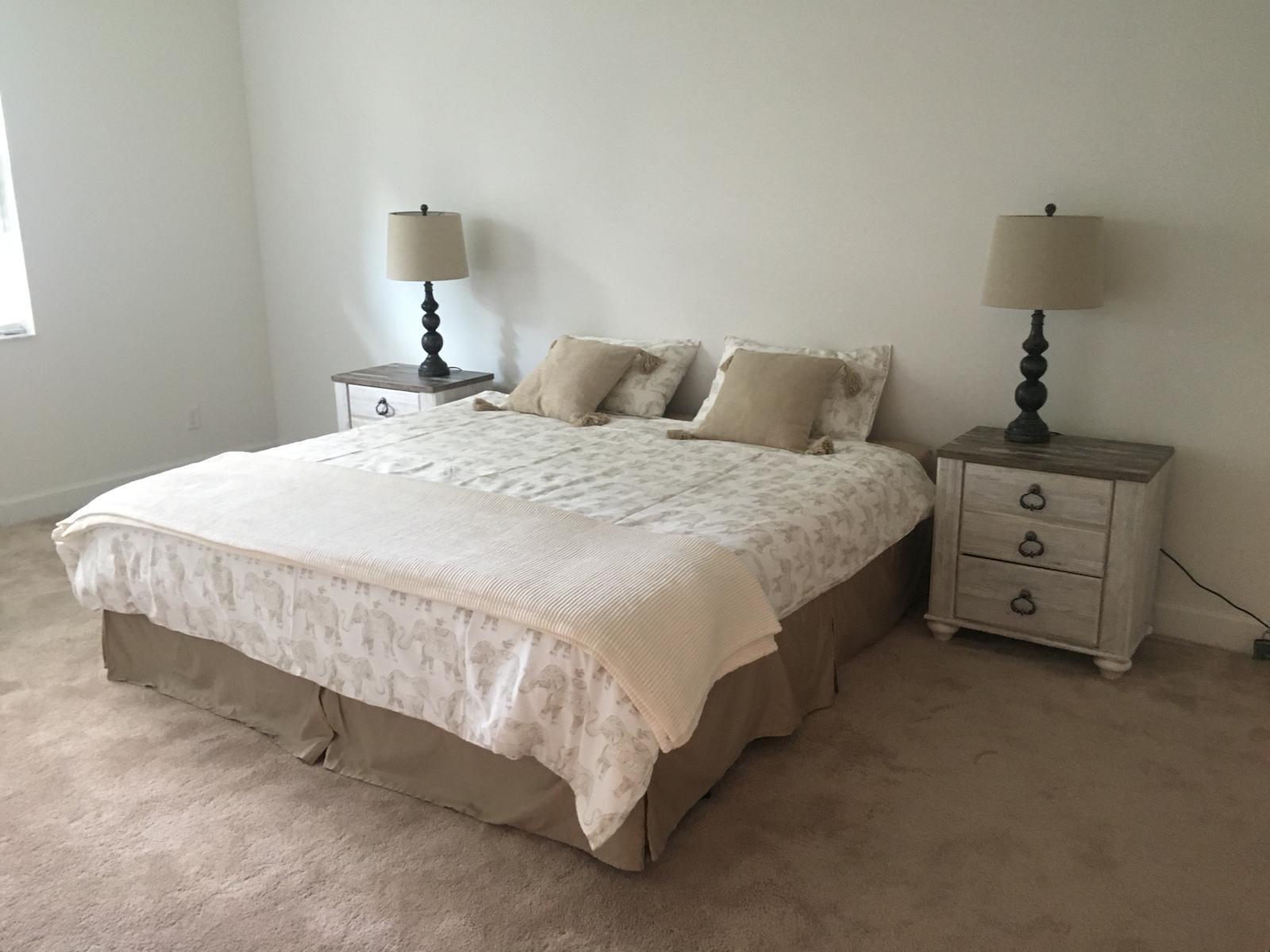 23045 Clear Echo Drive, Unit 76 Boca Raton, FL 33433 - Photo 22 of 35 a large bed sitting in a bedroom next to a lamp