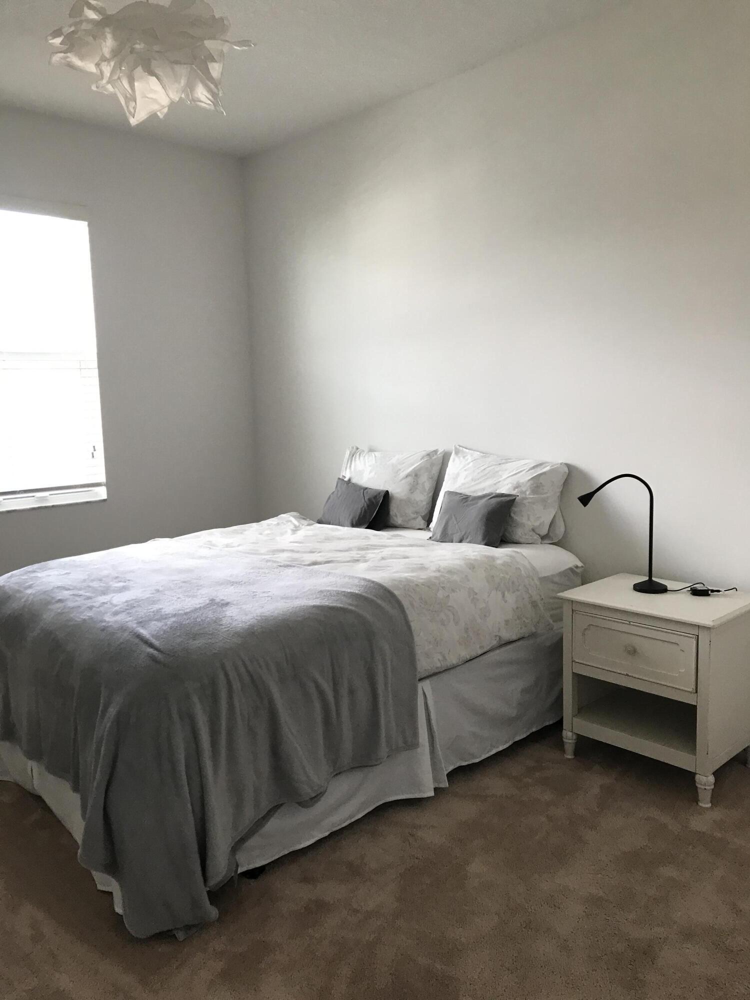 23045 Clear Echo Drive, Unit 76 Boca Raton, FL 33433 - Photo 23 of 35 a bedroom with bed and a window