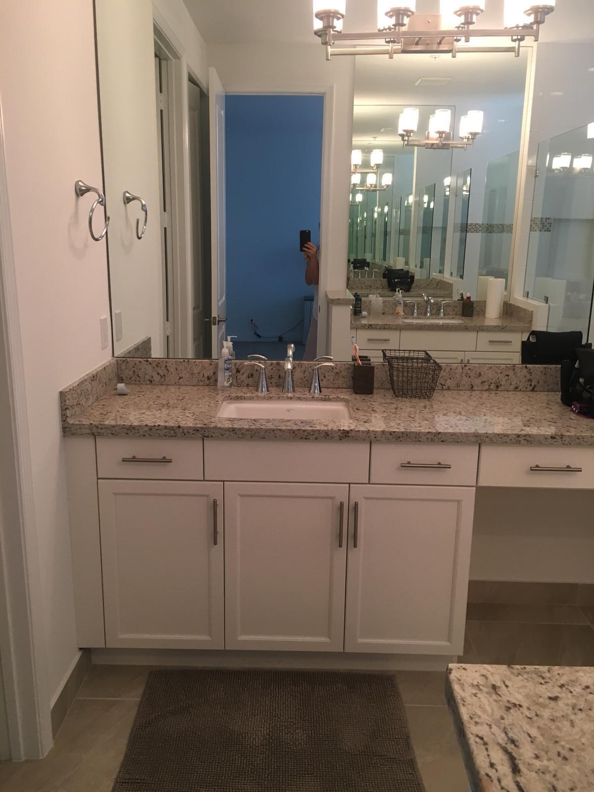 23045 Clear Echo Drive, Unit 76 Boca Raton, FL 33433 - Photo 30 of 35 a bathroom with a sink and a mirror