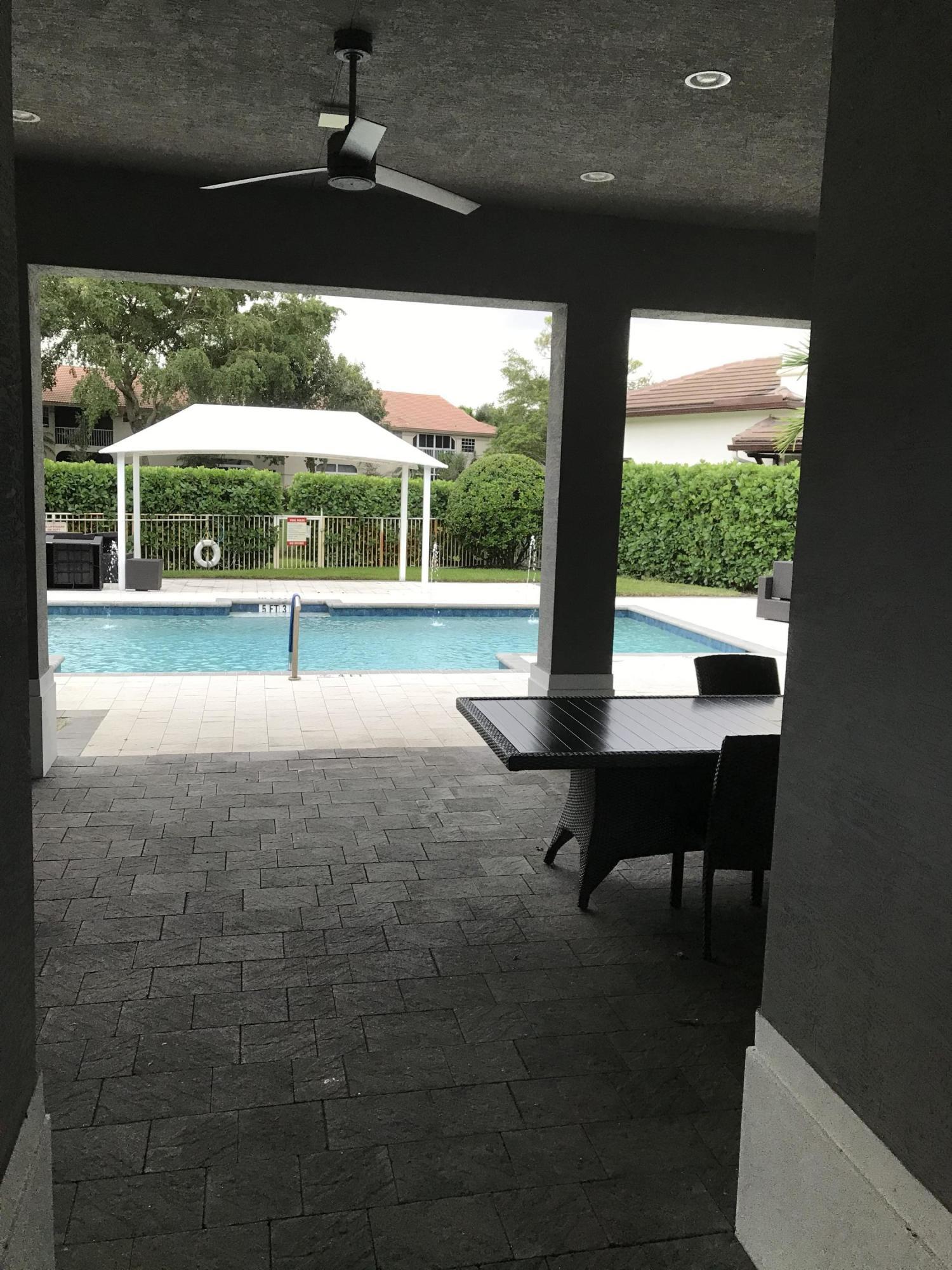 23045 Clear Echo Drive, Unit 76 Boca Raton, FL 33433 - Photo 3 of 35 a view of swimming pool with garden