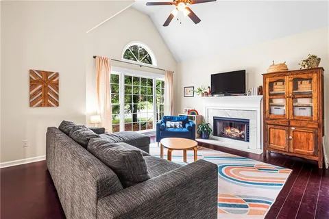 a living room with furniture a fireplace and a flat screen tv
