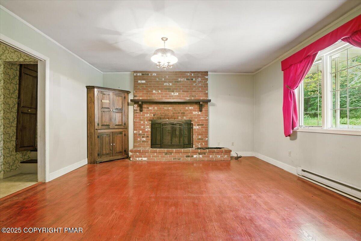 142 Pine Grove Road Kunkletown, PA 18058 - Photo 16 of 78 a view of an empty room with a fireplace and a window