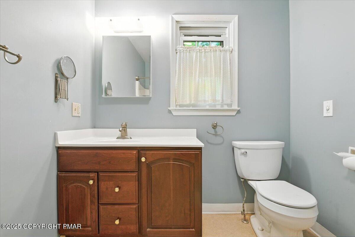 142 Pine Grove Road Kunkletown, PA 18058 - Photo 37 of 78 a bathroom with a toilet a sink a vanity and mirror
