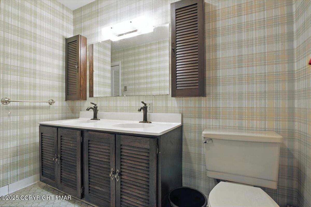 142 Pine Grove Road Kunkletown, PA 18058 - Photo 43 of 78 a bathroom with a sink toilet and mirror