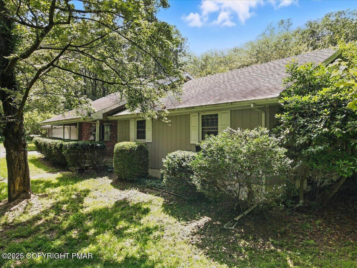 142 Pine Grove Road Kunkletown, PA 18058 - Photo 6 of 78 a front view of a house with a yard and potted plants