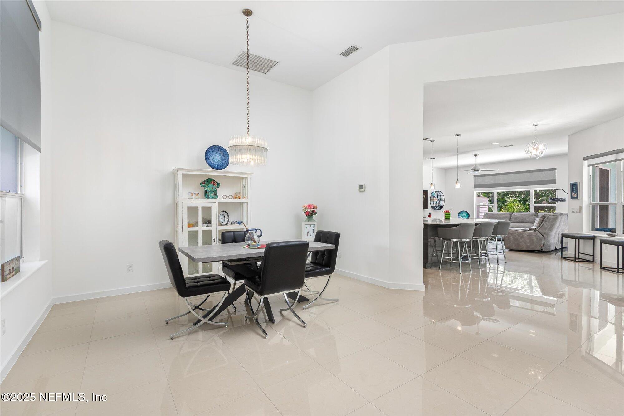 132 Bottlebrush Drive St. Augustine, FL 32086 - Photo 13 of 56 a dining room with furniture and wooden floor