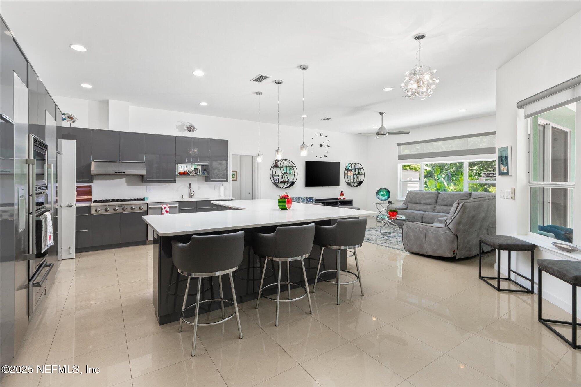 132 Bottlebrush Drive St. Augustine, FL 32086 - Photo 6 of 56 a kitchen with stainless steel appliances kitchen island granite countertop a table chairs sink and cabinets