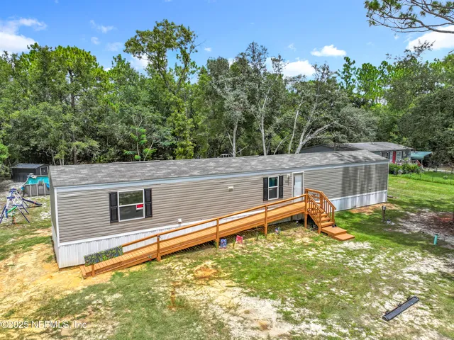 a backyard of a house with a yard and outdoor seating