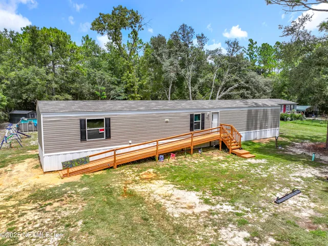 a backyard of a house with table and chairs