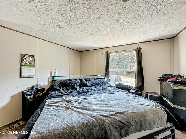 an aerial view of a house with a yard basket ball court and outdoor seating