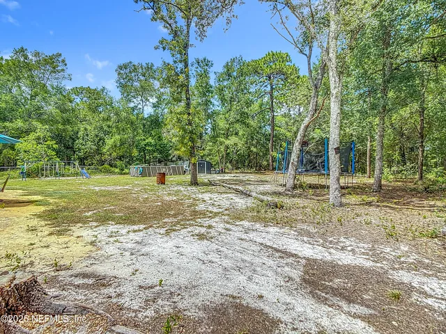 a backyard of a house with lots of green space