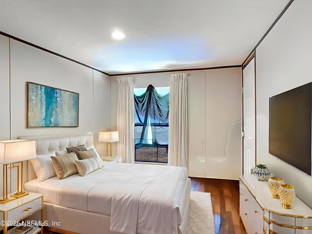 a bedroom with a bed and a flat screen tv