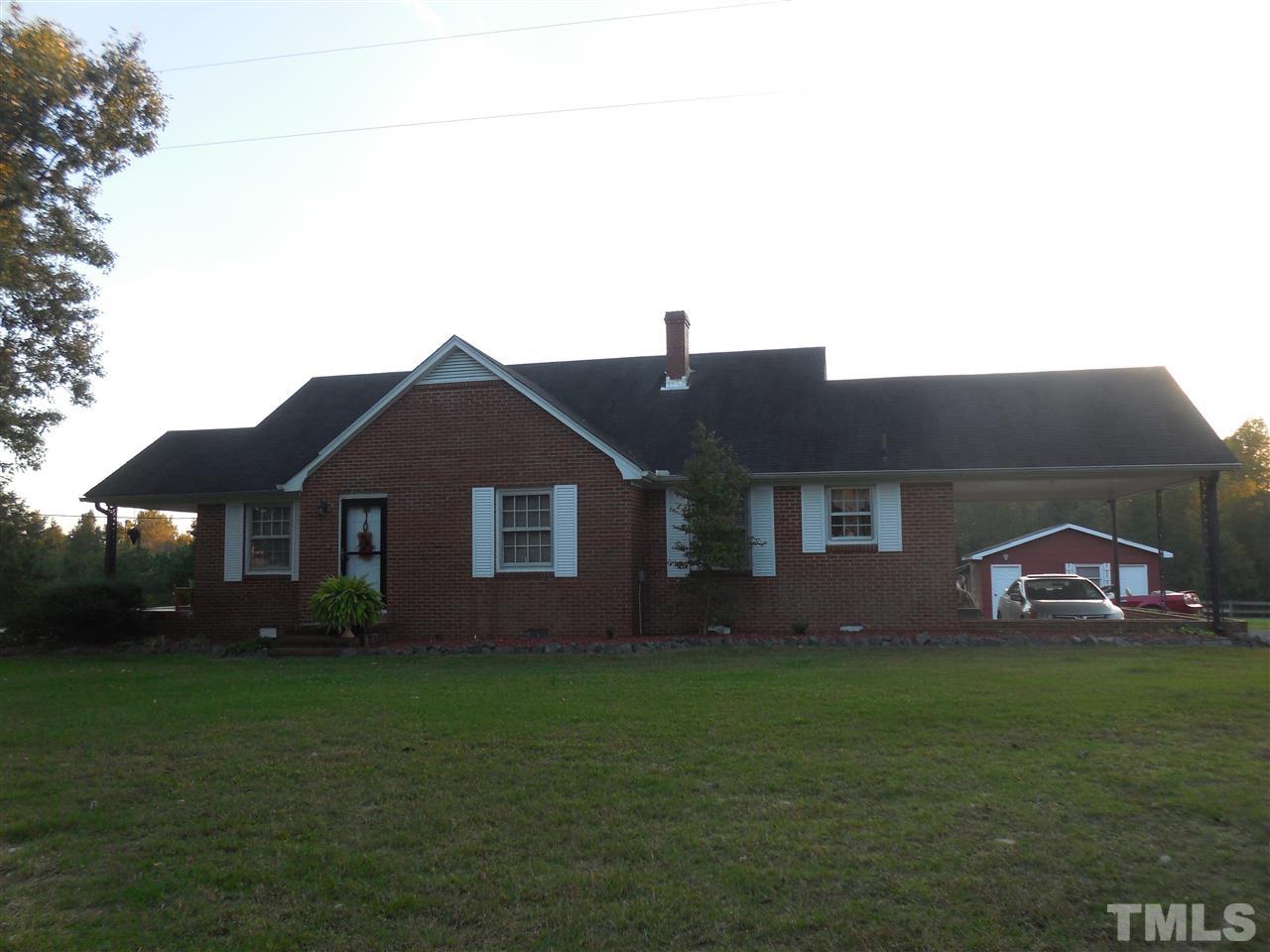 2150 Sanders Road Stem, NC 27581 - Photo 1 of 13 a front view of a house with garden