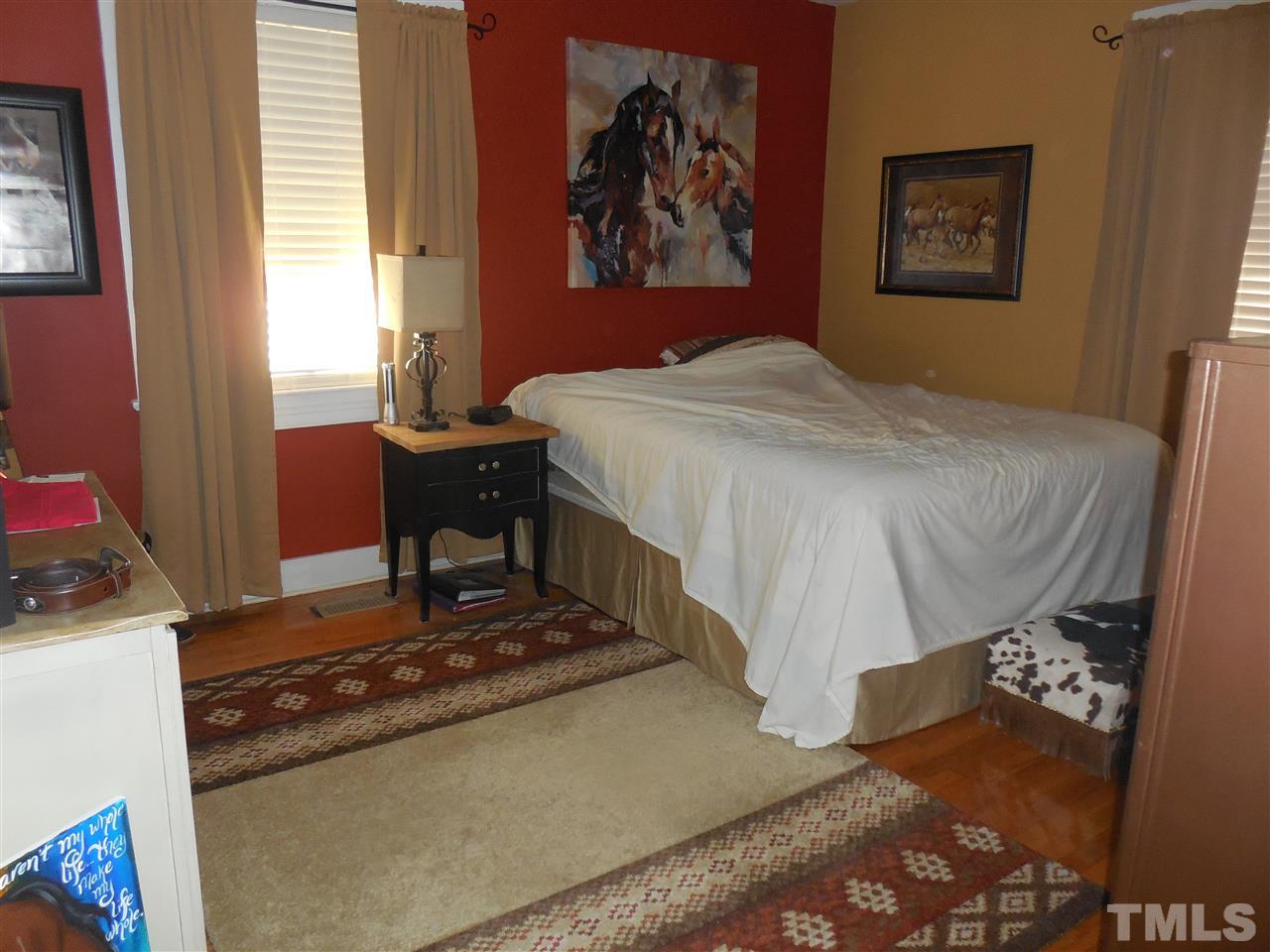 2150 Sanders Road Stem, NC 27581 - Photo 11 of 13 a bedroom with a bed and a window